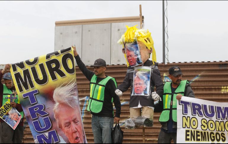 Policías federales hicieron dos filtros de revisión y dieron paso a un grupo de manifestantes que colocó mantas en el muro metálico. AFP/G. Arias