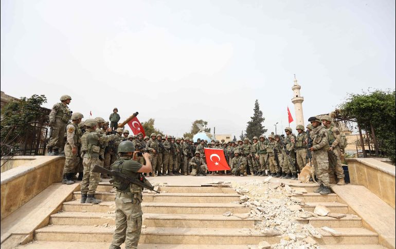 Militares posan para fotos con la bandera turca tras tomar la ciudad. La milicia kurda es considerada como una organización 