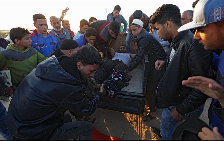 Manifestantes palestinos trasladan a un herido para que reciba atención médica. EFE/M. Saber