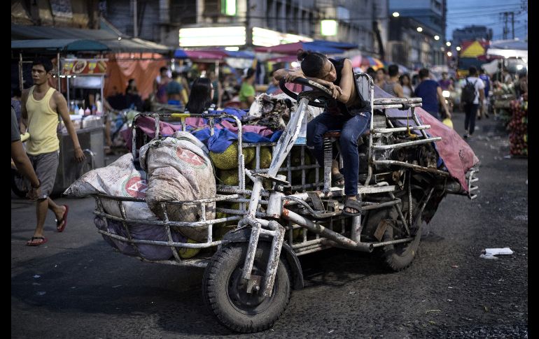 Un trabajador que entrega vegetales toma un descanso en el mercado Divisoria en Manila, Filipinas. AFP/N. Celis