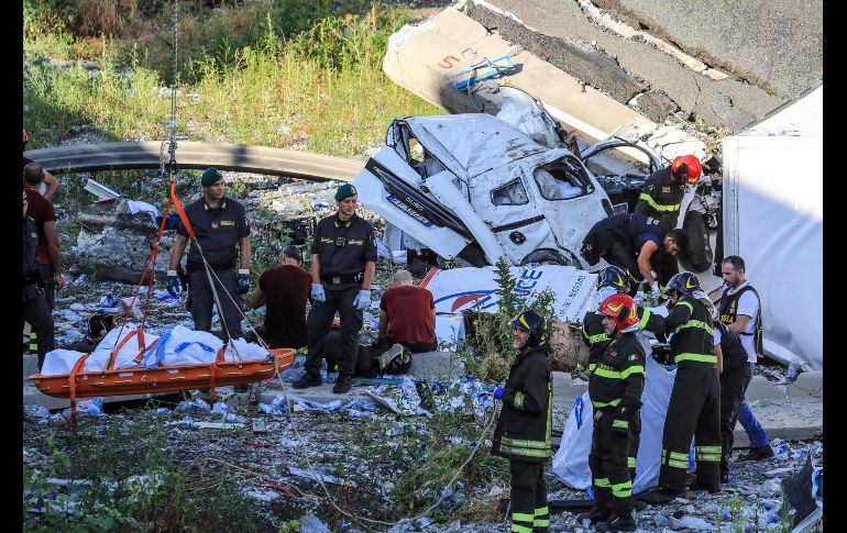 Rescatistas evacuan un cuerpo. Al menos una veintena de personas fallecieron hoy como consecuencia del derrumbe.