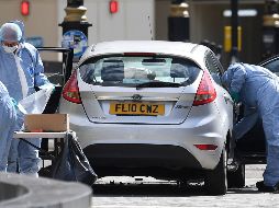 Oficiales forenses examinan el coche que chocó contra las barreras del Parlamento británico en Londres. EFE/A. Rain