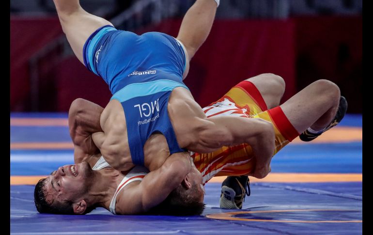 Khasanov Sirojiddin, de Uzbekiztan (parte inferior), lucha contra Batchuluun Batmagnai, de Mongolia (arriba), durante la competencia por la medalla de bronce de lucha libre de 65 kg en los Juegos Asiáticos 2018 en Yakarta, Indonesia. EFE/M. Irham