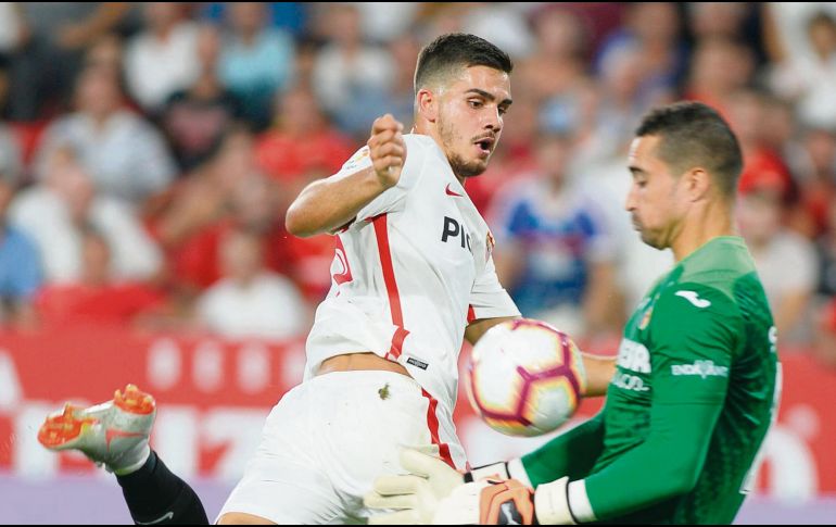 El delantero del Sevilla, André Silva, remata frente al arquero Sergio, quien se queda con el balón. AFP