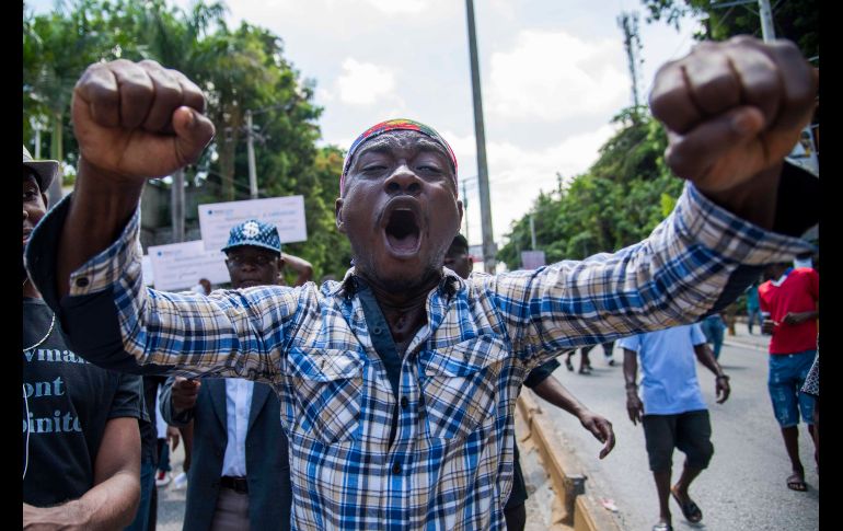Personas participan en una marcha para exigir a las autoridades que apliquen sanciones contra quienes supuestamente se beneficiaron de partidas millonarias del programa Petrocaribe, por el cual Venezuela suministra petróleo a bajos precios al país, en Puerto Príncipe, Haití. EFE/J. Hervé