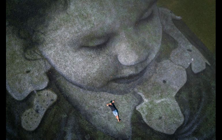 Saype posa con su obra de arte paisajístico, con la que apoya a la organización sin fines de lucro SOS Mediterranee, que rescata a migrantes del mar.