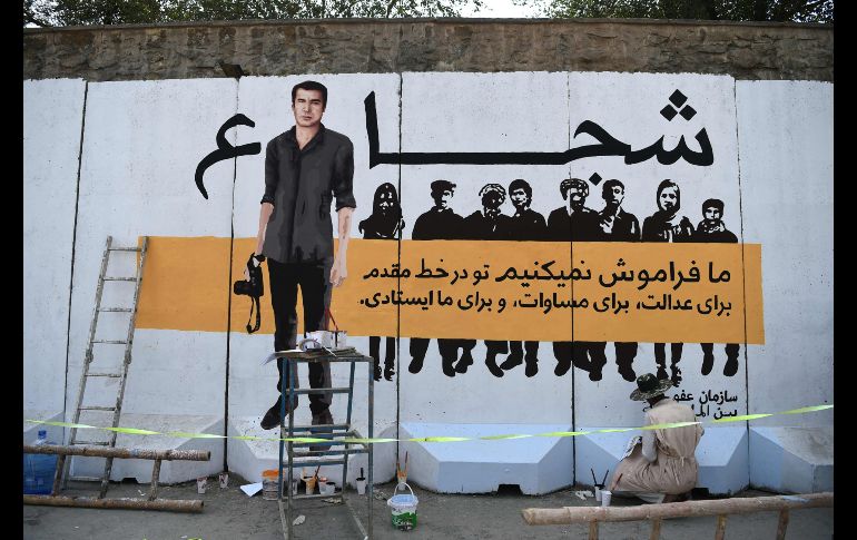 Un artista afgano pinta un mural con la imagen de Shah Marai, jefe de fotografía de la agencia AFP en Afganistán, quien murió en un atentado con bomba en Kabul. AFP/W. Kohsar