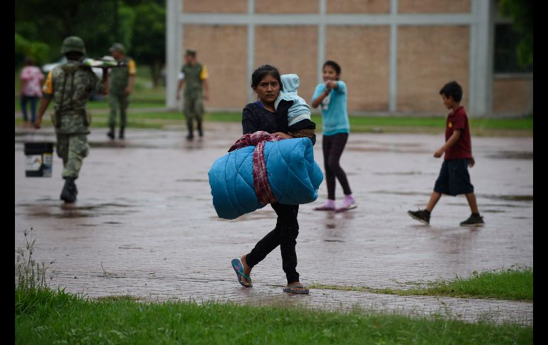 Una mujer se dirige a un albergue en Escuinapa.
