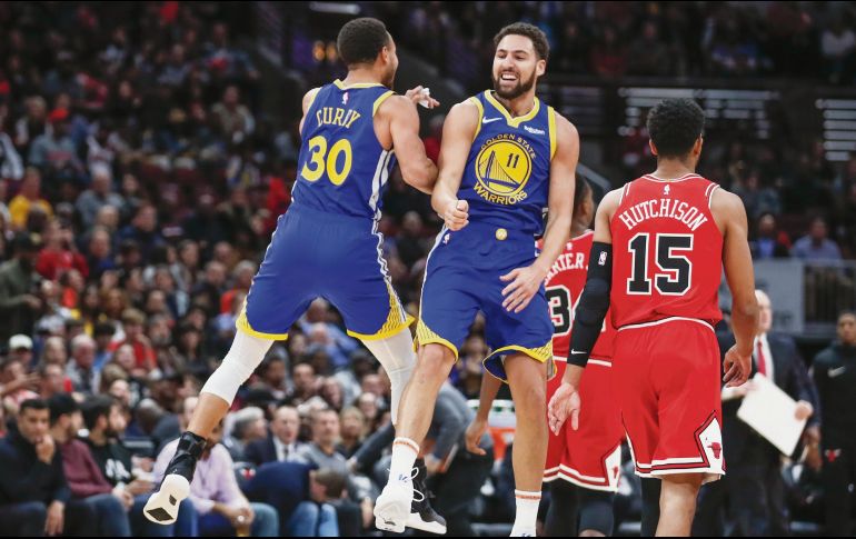 Histórico. Klay Thompson (#11) embocó 14 triples ayer frente a los Bulls. AP / K. Krzaczynski