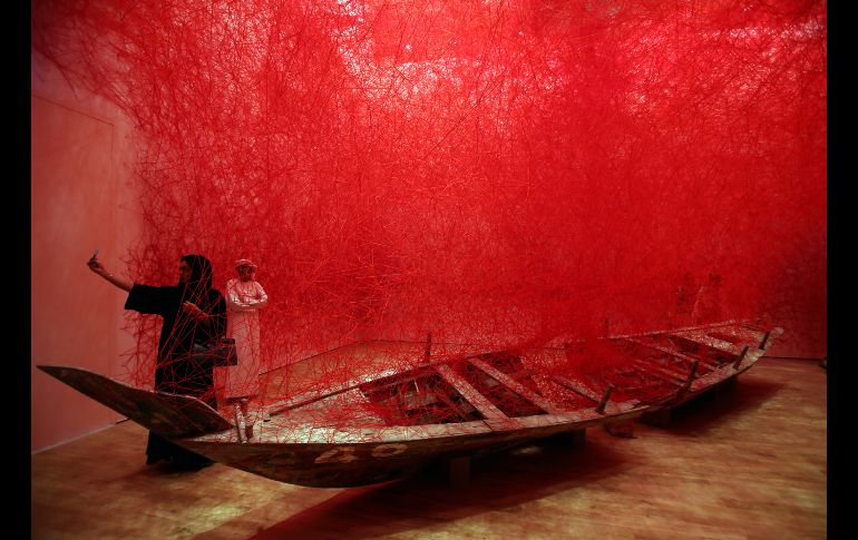 Una mujer se toma una selfie frente a la instalación 