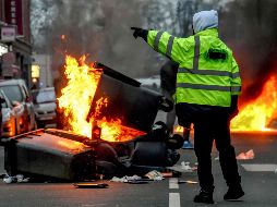 La Policía responde con gases lacrimógenos al lanzamiento de piedras y botellas contra los agentes por parte de manifestantes encapuchados. AFP / P. Huguen