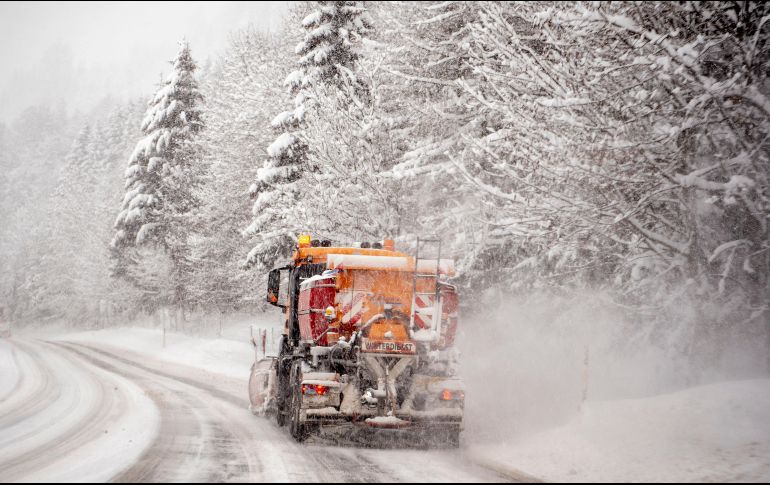 A lo largo de las carreteras, varios vehículos atrapados entre la nieve se alcanzaban a vislumbrar como parte del paisaje. EFE/C. Bruna