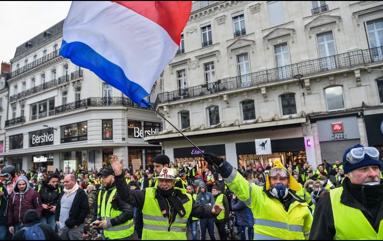 Las marchas se desarrollaron en medio de una amplia presencia policial y pese a las bajas temperaturas. AFP/L. Venance