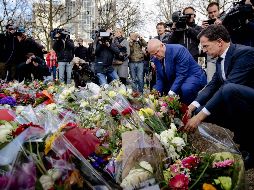 El primer ministro holandés, Mark Rutte (derecha) y el ministro de Justicia y Seguridad, Ferdinand Grapperhaus (izq) colocan ofrendas cerca de la escena del tiroteo. AFP / R. Van Lonkhuijsen