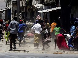 Civiles huyen de una pelea con armas de fuego mientras las fuerzas de seguridad somalíes luchan contra miembros de Al Shabab. EFE/Y. Warsame