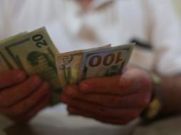 Banco Base prevé que el tipo de cambio cotice entre 18.88 y 19.10 pesos por dólar. EL INFORMADOR / ARCHIVO