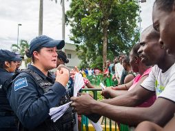 Migrantes africanos hablan con personal de seguridad a su llegada este miércoles a la Garita Siglo XXI del Instituto Nacional de Migración (INM) en Tapachula, Chiapas. EFE/L. Villalobos