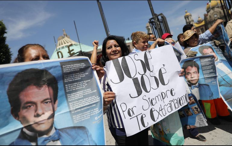 Seguidores portaban fotos, recortes de diarios, flores blancas y rojas para despedir a José José. EFE / S. Gutiérrez