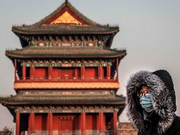 Una mujer con mascarilla en Pekín. A las autoridades les preocupa el masivo movimiento de viajeros por las vaciones del Año Nuevo chino, que arrancan este viernes. AFP/N. Asfouri