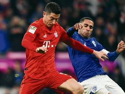 Lewandowski. El atacante polaco (izq.) encabeza la tabla de los mejores goleadores del torneo.  AFP