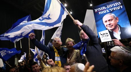 Partidarios del primer ministro israelí Benjamin Netanyahu celebran en Tel Aviv después de los resultados de la primera encuesta de salida para las elecciones. AP/O. Balilty