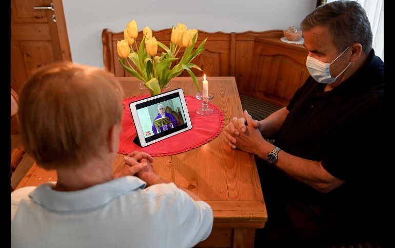 Miles de fieles alrededor del mundo siguieron la transmisión de la bendición papal. En la foto una pareja en Kaarst, Alemania. EFE / EPA / S. Steinbach