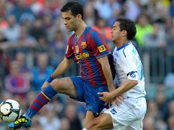 ''Llegué junto con Ronaldinho y, junto a la base que había, conseguimos muchos títulos importantes'', dijo el ex defensa a los medios oficiales de La Liga. AFP / ARCHIVO