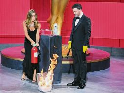 MÁXIMO CUIDADO. En la presentación de la primera terna, el comediante Jimmy Kimmel tomó con guantes la tarjeta, sin embargo tras rociarla con spray sanitizante la depositó en un cesto de basura para prenderle fuego y “matar los virus”. Por supuesto ahí estuvo Jennifer Aniston para apagar el pequeño incendio. AFP