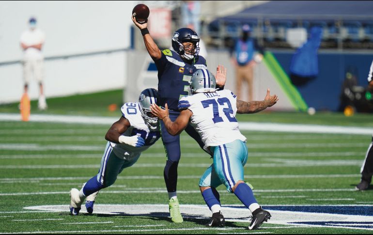 PASO SEGURO. Luego de tres juegos de temporada regular, Russell Wilson acumula 14 pases de TD; ayer vacunó a los Cowboys con cinco envíos anotadores. AP• E. Thompson