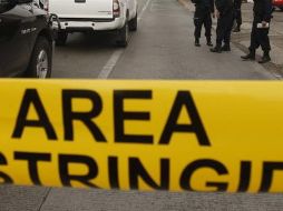 Elementos de la Fiscalía estatal y personal del Ministerio Público acordonaron la zona. EL INFORMADOR / ARCHIVO