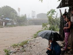 Pobladores de San Pedro Sula mira la crecida del río Bermejo. AP/D. Martínez