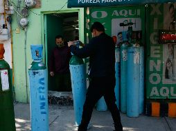 ESCASEZ. Un trabajador maniobra un tanque de oxígeno para rellenarlo en la Ciudad de México. AP