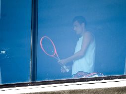 El tenista Bernard Tomic se ejercita hoy en un cuarto de hotel en Melbourne. Hay 72 tenistas en confinamiento estricto en sus habitaciones de hotel. AFP/W. West
