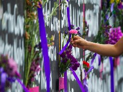 Continúa el movimiento de personas que llegan a la valla frente a Palacio Nacional para colocar flores y velas para recordar a mexicanas víctimas de la violencia. AFP/ARCHIVO