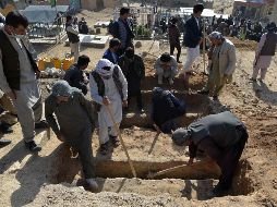 Familiares de niñas fallecidas en ataque cavan hoy tumbas para sepultarlas en el cementerio de Dasht-e-Barchi, a las afueras de Kabul. AFP/W. Kohsar