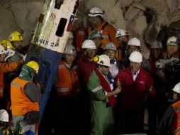 El último minero rescatado, Luiz Urzúa (i), saluda al presidente de Chile, Sebastián Piñera (d) el 13 de octubre de 2010 luego de llegar a la superficie dentro de la cápsula Fénix. EFE/ARCHIVO