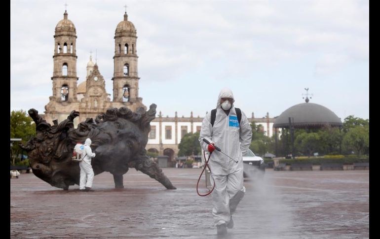 Un grupo de brigadistas realiza trabajos de desinfección y limpieza de áreas públicas en el municipio de Zapopan. EFE/F. Guasco
