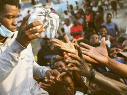 Hambre. Miles de haitianos esperan la ayuda humanitaria para abastecer a sus familias, luego de perderlo todo durante el sismo de la semana pasada. AP