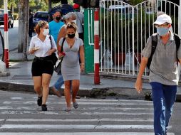 Varias personas usan mascarilla mientras caminan por una calle en La Habana. EFE/ARCHIVO