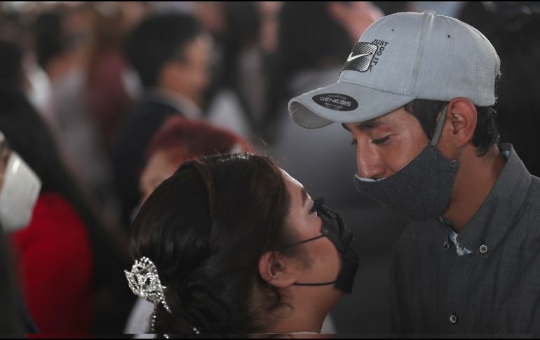 Los velos, vestidos de novia, flores y adornos se complementaron con los cubrebocas que en todo momento portaron los contrayentes. EFE/S. Gutiérrez