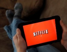 FILE - In this Friday, Jan. 17, 2014, file photo, a person displays Netflix on a tablet in North Andover, Mass. Netflix reports earnings Monday, April 17, 2017. (AP Photo/Elise Amendola, File) Earns Netflix-JAN. 17, 2014, FILE PHOTO