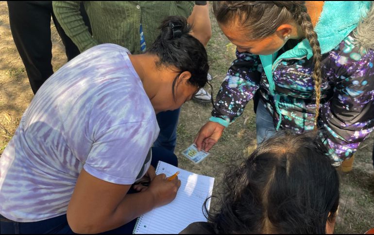 Se anotan en una libreta para firmar después una carta solicitando el asilo. EFE