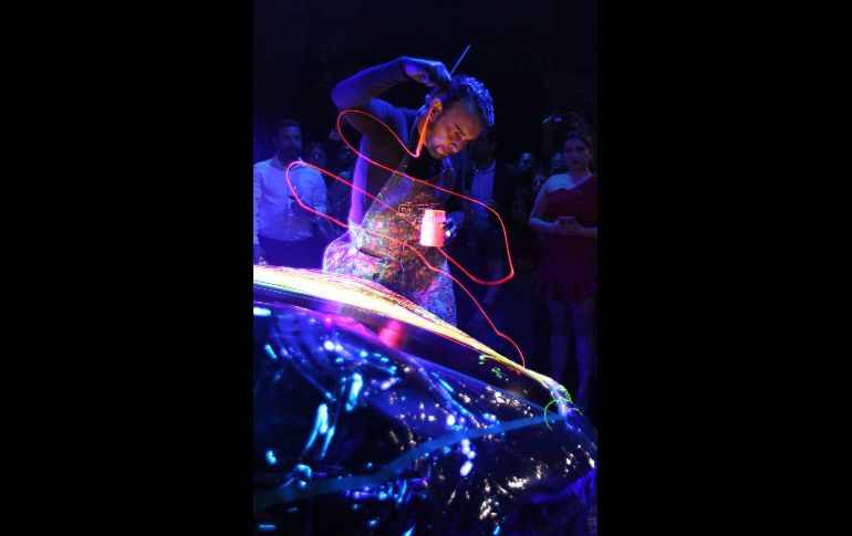 El artista intervino un automóvil de lujo enmarcada la actividad por una atmósfera en destellos neón que provenían de la obra expuesta y además con música de DJ de fondo. EL INFORMADOR / A. Camacho