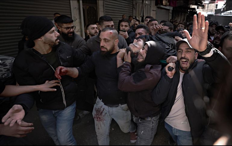 Palestinos cargan el cuerpo de una de las víctimas. EFE/A. Badarneh