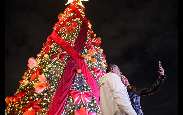 Adornado con cintas rojas y nochebuenas, el árbol fue iluminado con la catedral de fondo, seguido de un espectáculo de fuegos artificiales de todos colores, que chicos y grandes captaron con sus teléfonos celulares. EL INFORMADOR/ H. FIGUEROA