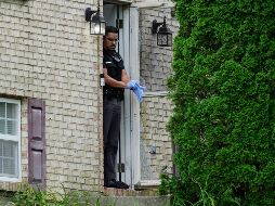 Un miembro del Departamento de Policía de Florence, Kentucky, frente a la puerta de una casa que fue escenario de un tiroteo, el sábado 6 de julio de 2024, en Florence, Kentucky. (AP Foto/Carolyn Kaster)