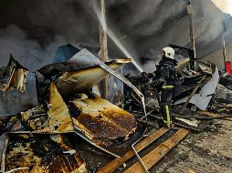 Bomberos extinguen un incendio tras un ataque con cohetes rusos en Dobropillya, en la región de Donetsk, en el Este de Ucrania. AFP/Servicio de Emergencias Ucraniano