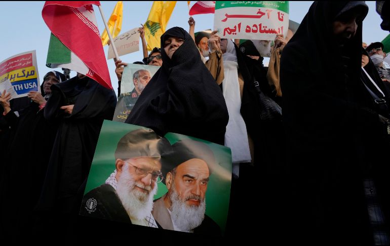 Una mujer iraní sostiene un cartel del ayatolá Jomeini, el fallecido líder revolucionario iraní, a la derecha, y el actual líder supremo, el ayatolá Alí Jamenei. AP / V. Salemi