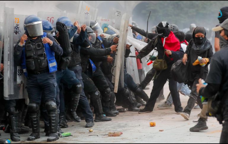 Policías son agredidos durante una manifestación por los 57 años de la matanza de Tlatelolco del 2 de octubre de 1968, en la Ciudad de México. EFE / ARCHIVO