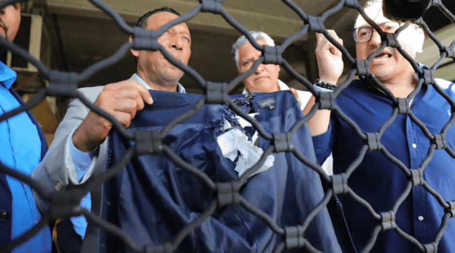 Personas muestran la chaqueta que usaba la diputada del Partido Nacional Gladys Aurora López, luego de ser afectada por un artefacto explosivo. EFE / G. AMADOR